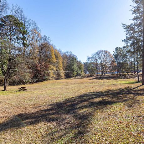 large open field with grass and picnic table